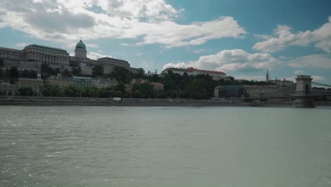 Boat-ride-through-Danube,-summer-afternoon-passing-by-budacastle,-little-overcast