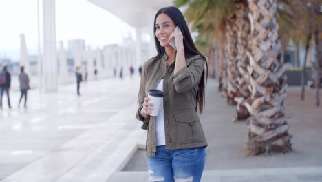 young woman talking on her mobile in town