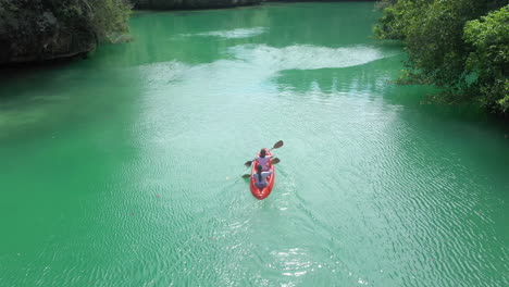 couple kayaking in a tropical river