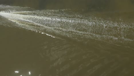 top down shot of a blue speedboat on the kenh te canal