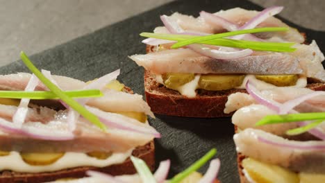 herring sandwiches with pickled onions and dill