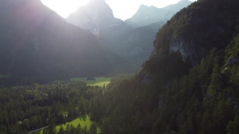 Aerial-of-mountain-valley-at-dawn-with-lens-flare