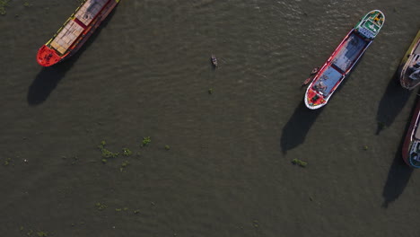 aerial: larger cargo boats docking at sadar ghat river port, dhaka, bangladesh