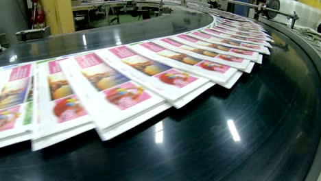 print plant factory, magazine transports on conveyor belt line after printing units and folder