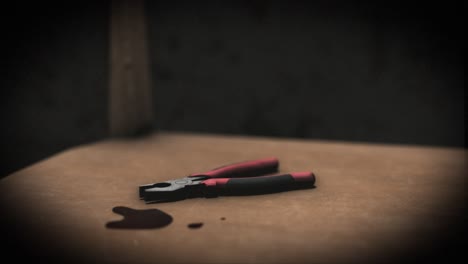 high quality, close-up shot of a pair of bloody pliers on a chair in a sinister interrogation torture chamber, with dark creepy grungy walls, blood on the floor, under a spotlight