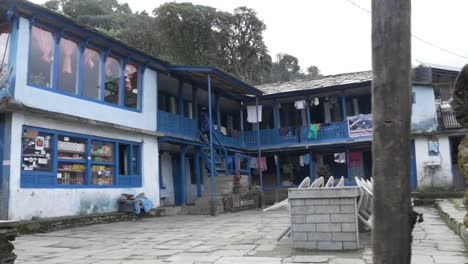 Mujer-Joven-Subiendo-Escalones-En-Una-Casa-En-La-Aldea-Del-Himalaya-En-Nepal,-Región-De-Annapurna,-Cámara-Lenta