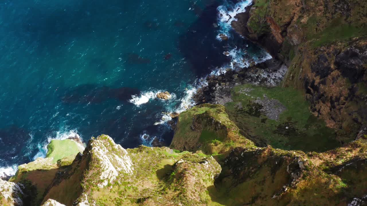 Top-Down Drone View of Horn Head Cliffs with Slow Upward Pan Over Rugged Irish Coastline And Blue Foamy Ocean Waves