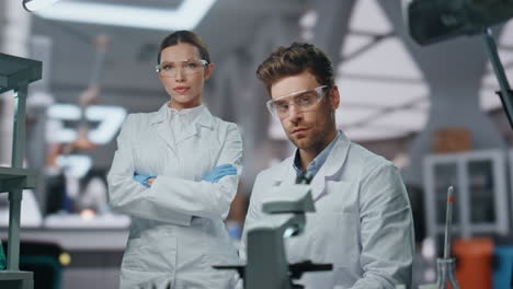 portrait two medical researchers in glasses gloves at clinic equipment close up.