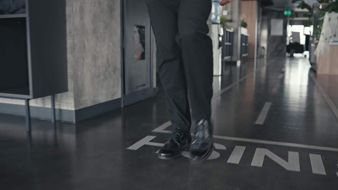 View of business people's legs and shoes in an office hallway