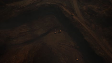 arial view of the opencast mine. front end loader loading sand into dump truck in open pit. heavy mining machinery working in quarry. truck transports minerals in opencast