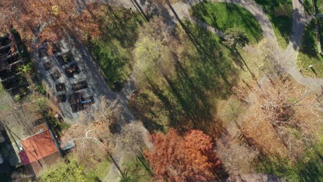 Autumn-colored-trees-in-the-park,-Kraljevo,-Serbia,-high-angle-drone-shot