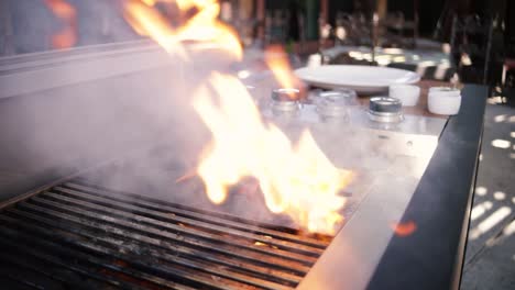 Adding-oil-to-vegetables-on-a-flaming-grill