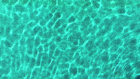 blue-water-surface-of-a-pool-aerial-top-shot-sunny-day