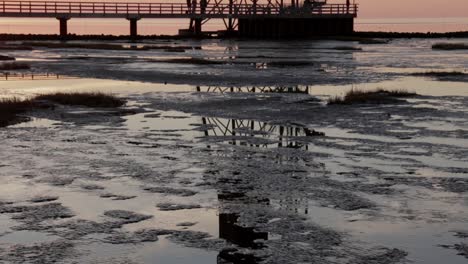 old antique lighthouse at the north sea while low tide and sunset