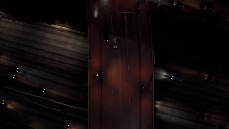 descending over a highway bridge in dtla at night