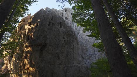 panning from the left to right, revealing the historic archeological thracian shrine called the eagle's rock or more commonly known as orlovi skali, located in rhodope mountains in bulgaria