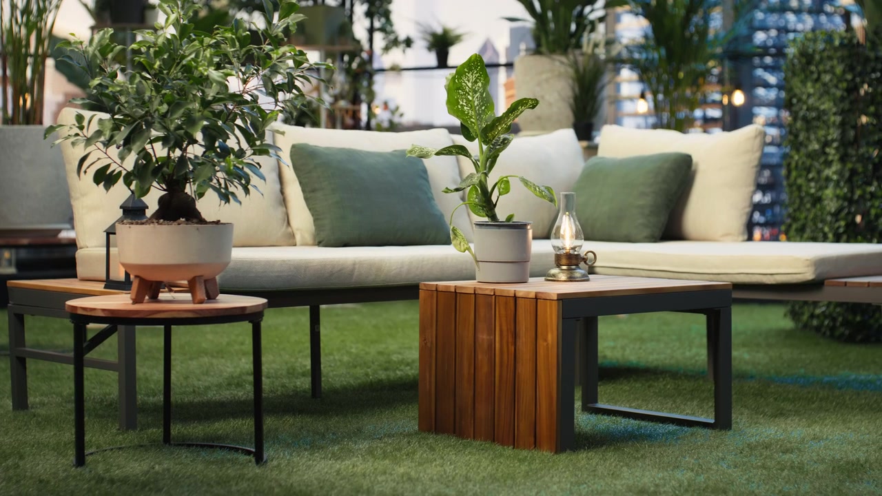Empty rooftop terrace with lounge seating, plants and wooden furniture