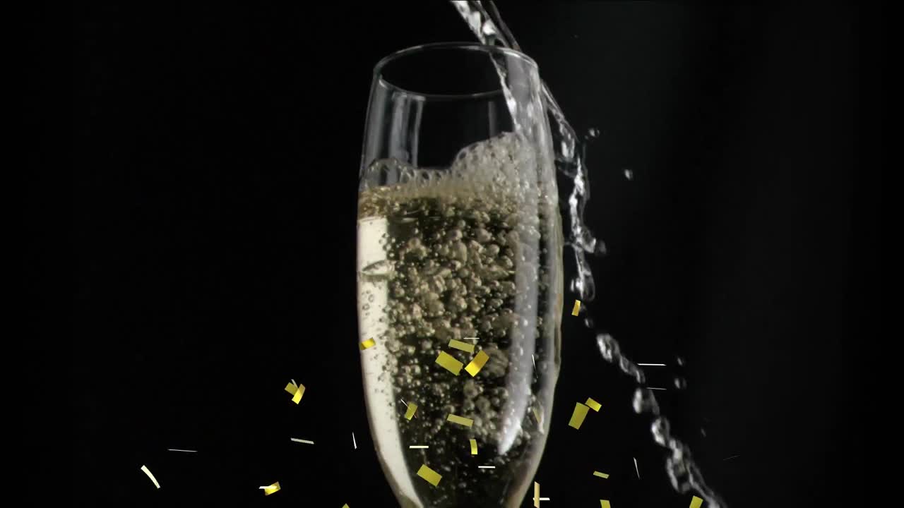 검은색 바탕에  ⁇ 페인 잔 위에 떨어지는 금색 콘페티의 애니메이션