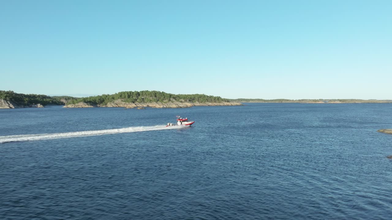 The sun shines brightly over serene waters as a boat glides smoothly, revealing a stunning panorama of rocky coastlines and lush greenery in the background