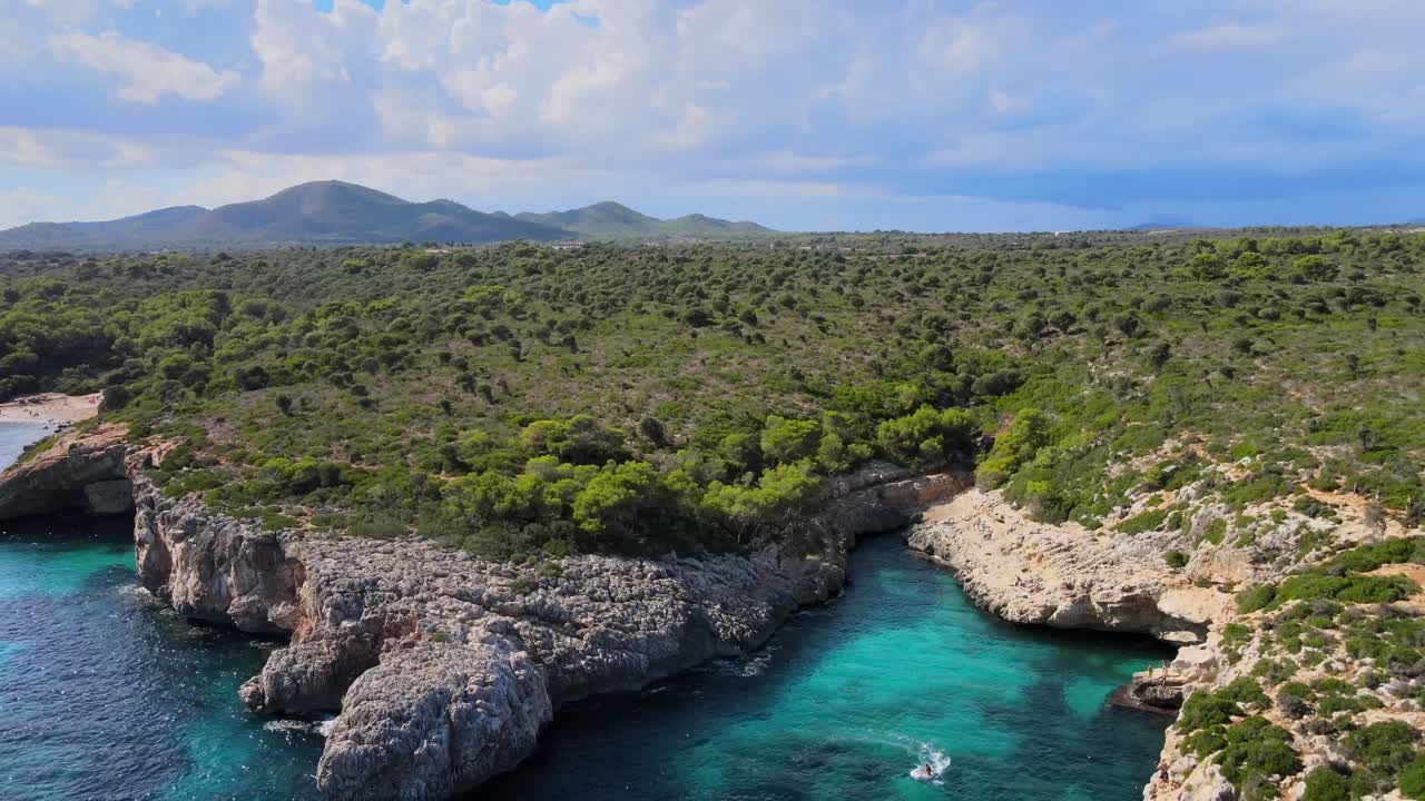 Experience the natural beauty of Cala Varques in Majorca with its rocky cliffs and clear turquoise waters. This serene coastal landscape showcases the charm of Porto Cristo and Calas de Mallorca.