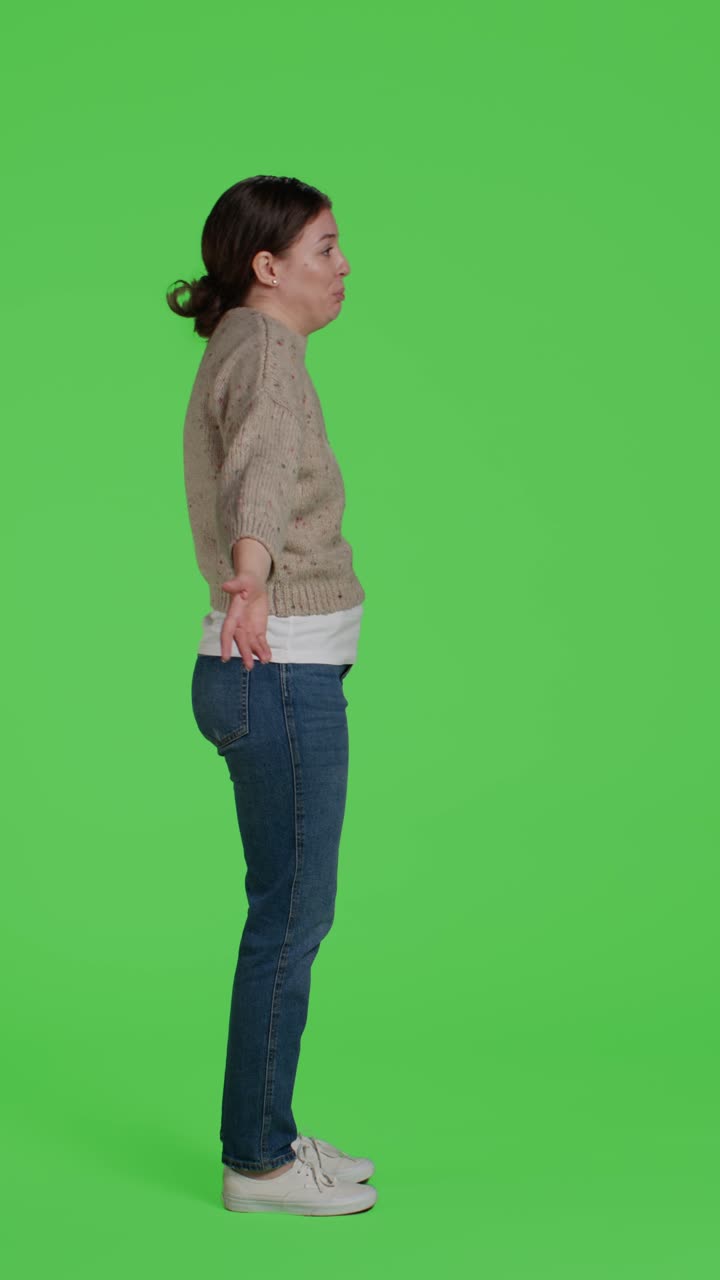 Vertical video: Profile of doubtful adult doing i dont know sign in studio