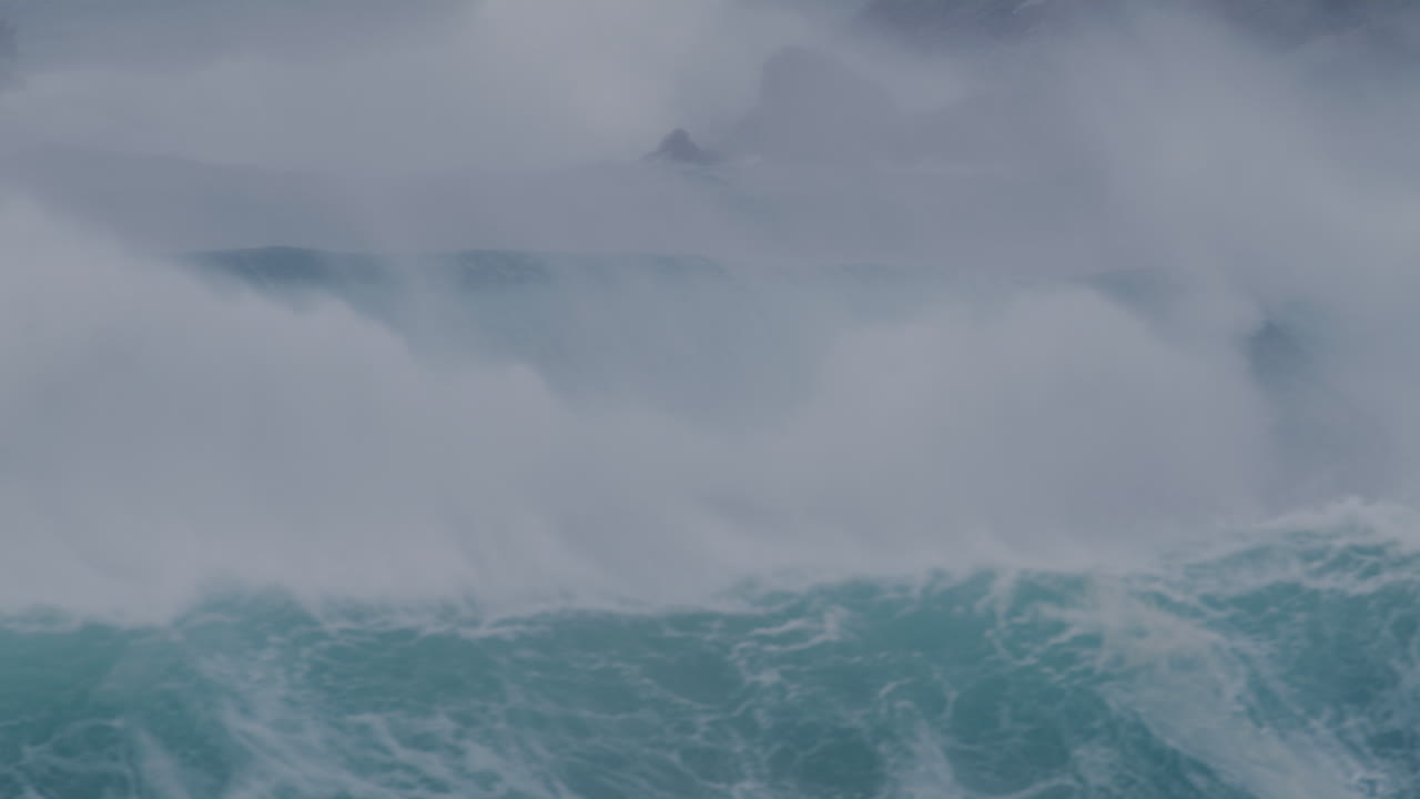Crashing waves in Sydney, Australia, with strong currents and deep blue ocean water swirling.