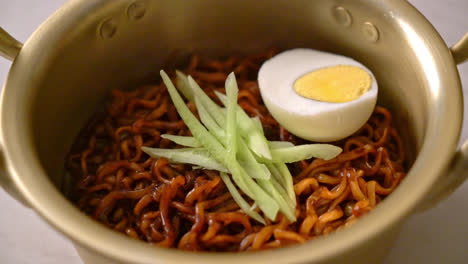 korean instant noodle with black bean sauce topped cucumber and boiled egg - korean food style