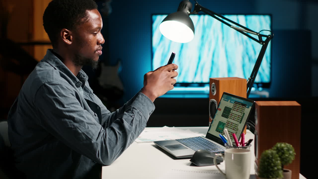 Independent adult teleworking from home and using his mobile phone