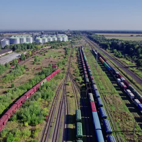 aerial view of cargo train at rail yard and grain silos