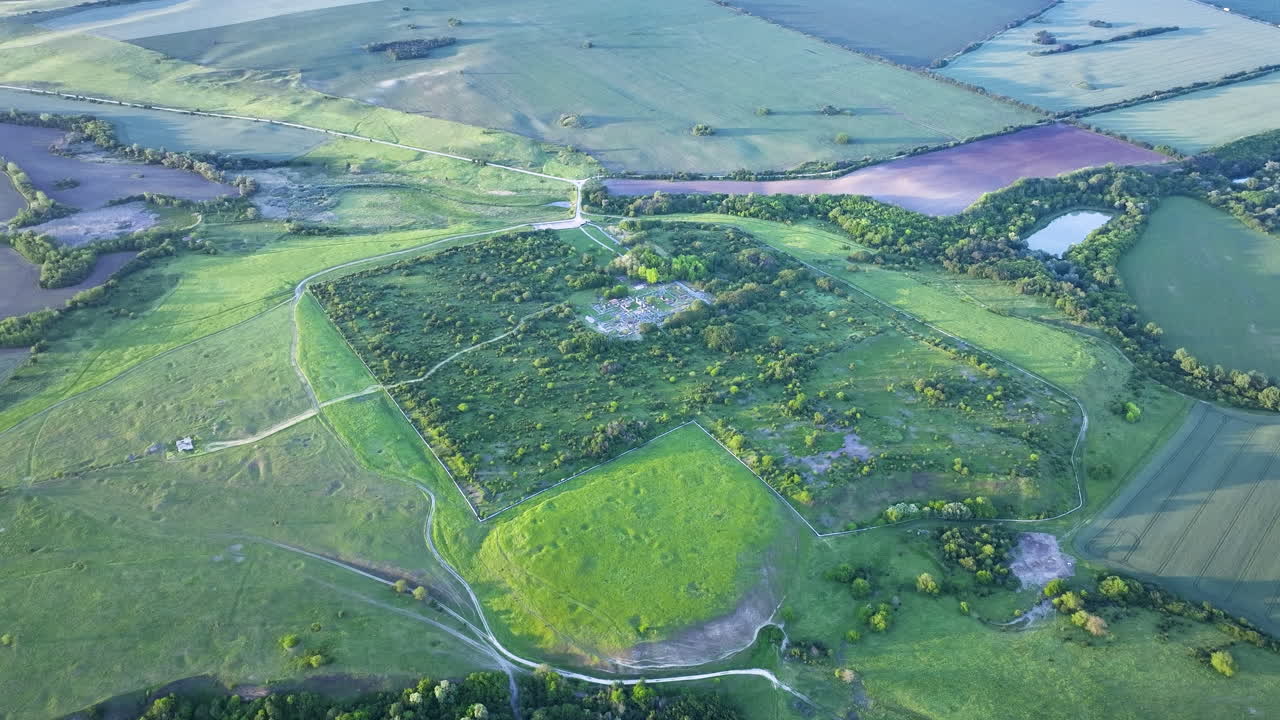 Distant drone view of Nicopolis ad Istrum during sunset, with sunlight casting over the Roman city remains