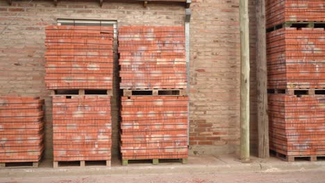 pallets of orange bricks for construction