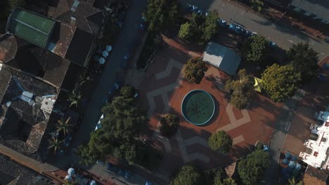 Drone-aerial-Bird's-eye-view-of-the-main-square-of-the-city-in-El-peñol-Guatapé,-Medeliin,-Colombia