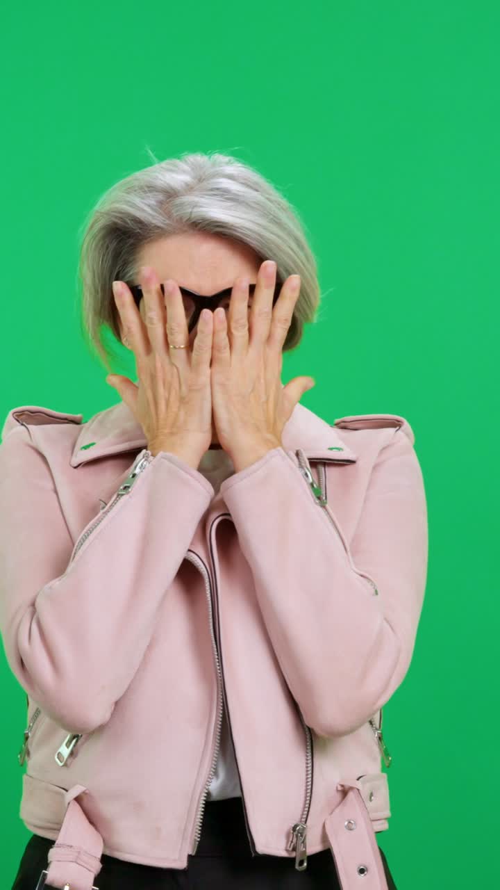Mature Woman Reacting with Surprise and Disbelief on Green Screen