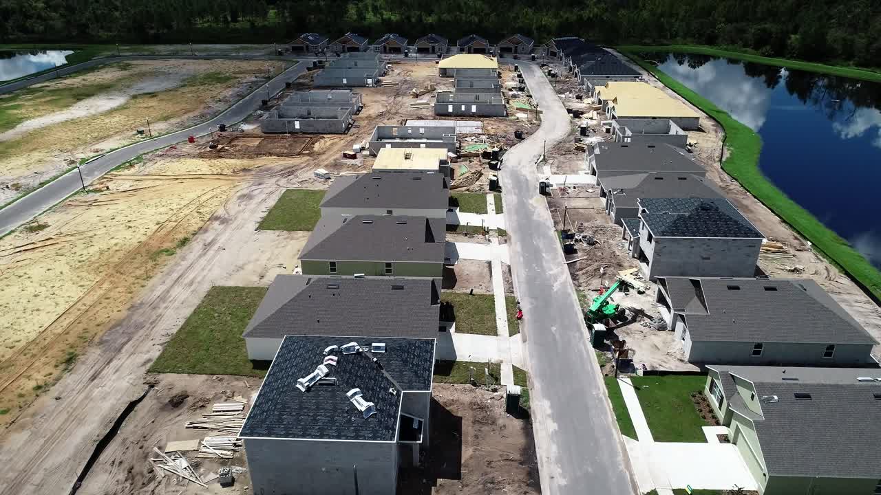 Aerial views of a residential neighborhood under construction.