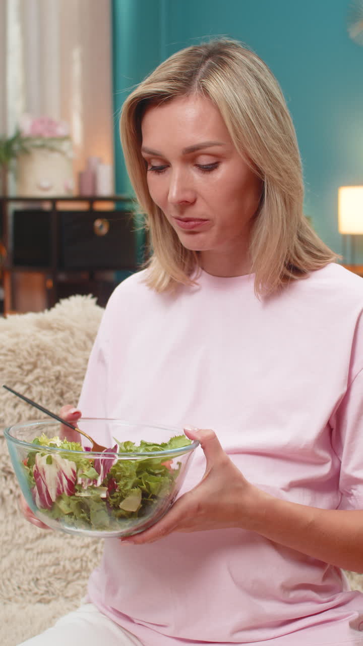 Pregnant woman eating fresh cabbage tomato salad showing healthy vitamin nutrition during pregnancy