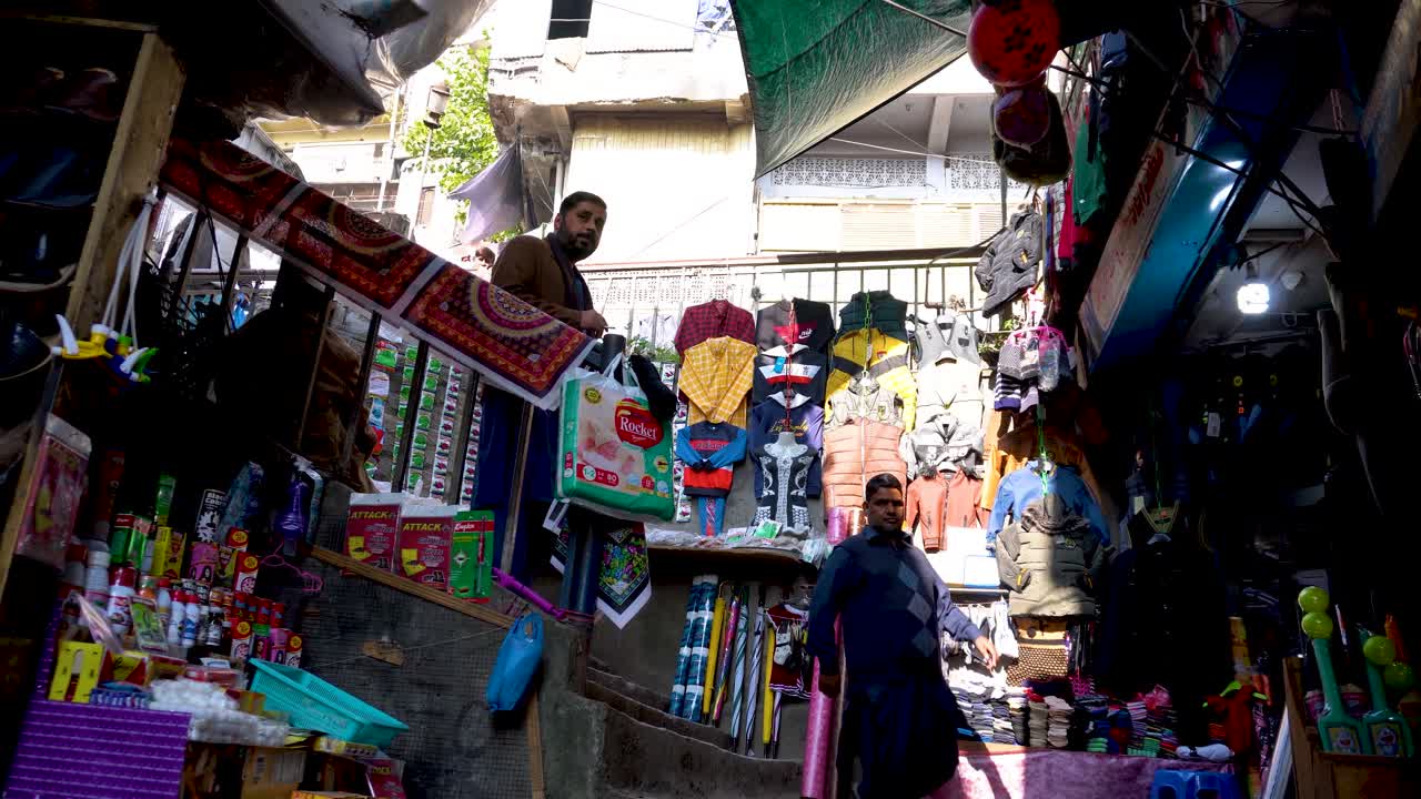 Colorful street stalls selling clothes, rugs, and household items. Muzaffarabad, Azad Kashmir