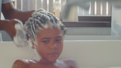 african american kid bathing with dad