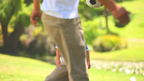 young boy and his father playing with a ball