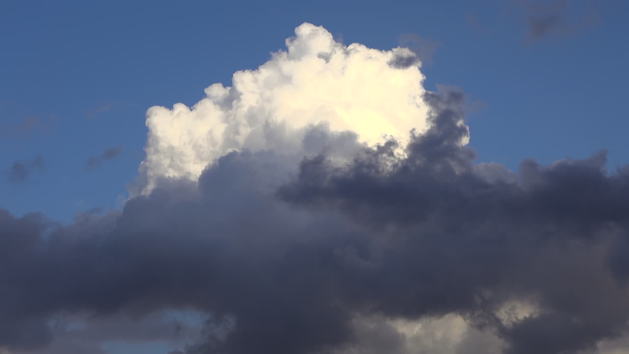 White and grey clouds moving on the blue sky