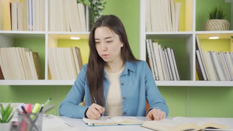 asian teenage girl does not want to study.