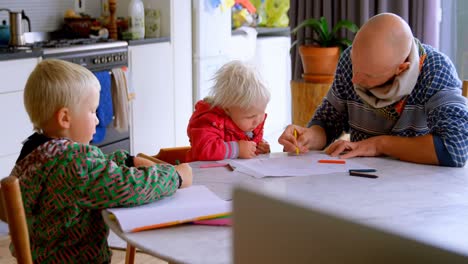 father helping his daughter in drawing at home 4k