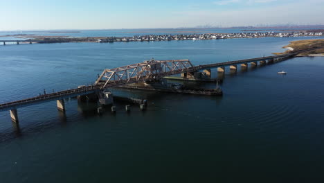 a high angle shot of an elevated train track which crosses a bay in queens, ny