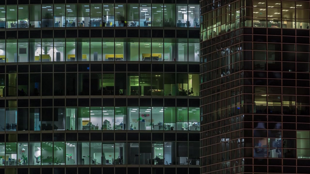 Close up view to panoramic office windows in Skyscrapers International Business Center of City at night timelapse from top