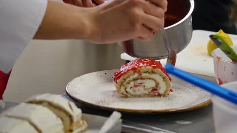 chef preparing a strawberry swiss roll dessert