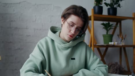 young woman drawing flowers in an art studio