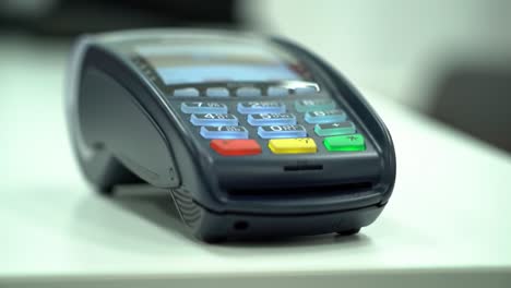 a close-up view of a payment terminal showing numeric keypad and interface, capturing the transaction process and modern payment solutions