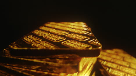 a stack of credit suisse gold bars on a rotating platform against a dark background - close up