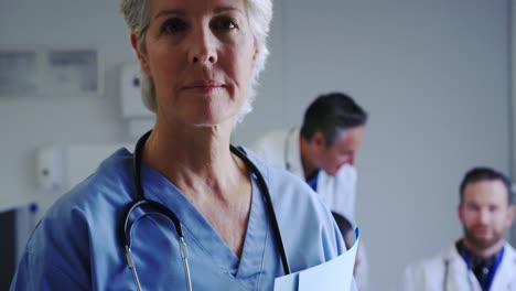 close-up of caucasian female doctor standing with medical file in hospital