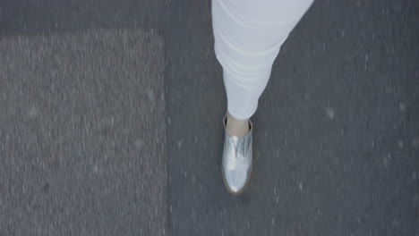 Mujer-Caminando-Por-Una-Carretera-Asfaltada-Con-Elegantes-Zapatos-Plateados-Paseando-Informalmente-En-La-Ciudad-Vista-Superior