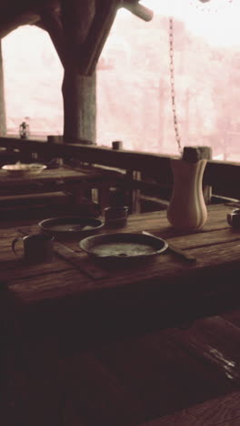 a rustic wooden table and chairs in an outdoor dining area.